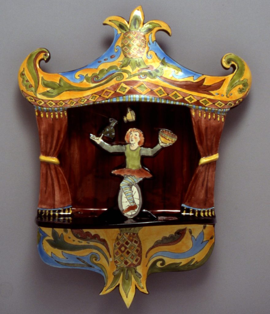 Ceramic sculpture by Teresa Bergen showing a juggling unicyclist on stage.