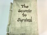 Ceramic book by Marla Benton titled "The Secrets to Survival"